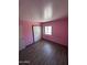 A bedroom featuring wood-look flooring and a sliding closet at 12422 N 121St Dr, El Mirage, AZ 85335