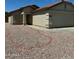 Charming single-story home featuring low-maintenance desert landscaping and a two-car garage at 12422 N 121St Dr, El Mirage, AZ 85335