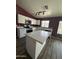 Modern kitchen with white cabinets, quartz countertops, and a large island at 12422 N 121St Dr, El Mirage, AZ 85335