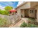 Charming front entrance with a covered patio, privacy wall, and beautifully landscaped surroundings at 12714 W Copperstone Dr, Sun City West, AZ 85375