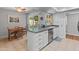 Kitchen with a breakfast bar, stainless steel dishwasher and tile floors at 12714 W Copperstone Dr, Sun City West, AZ 85375