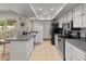 Bright kitchen featuring white cabinets and stainless steel appliances at 12714 W Copperstone Dr, Sun City West, AZ 85375