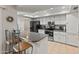 Spacious kitchen with breakfast bar, stainless steel appliances and light tile floors at 12714 W Copperstone Dr, Sun City West, AZ 85375