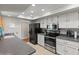 Modern kitchen with stainless steel appliances and white cabinets at 12714 W Copperstone Dr, Sun City West, AZ 85375