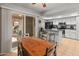 Eat-in kitchen with white cabinets, modern appliances, tile floors, and a sliding door to the outdoor patio at 12714 W Copperstone Dr, Sun City West, AZ 85375