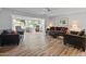 Cozy living room featuring hardwood floors, comfortable seating, and plenty of natural light at 12714 W Copperstone Dr, Sun City West, AZ 85375