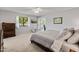 Bright main bedroom features neutral walls, carpet, window and ceiling fan at 12714 W Copperstone Dr, Sun City West, AZ 85375