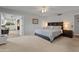 Spacious main bedroom with carpeted floors, a queen-sized bed, and an open layout to another room at 12714 W Copperstone Dr, Sun City West, AZ 85375