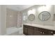 Bathroom featuring a double vanity with dark wood cabinets, and a shower-tub combo at 139 W Granada Rd, Phoenix, AZ 85003