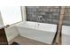 Stylish white soaking tub with chrome fixtures and tile walls at 139 W Granada Rd, Phoenix, AZ 85003