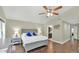 Spacious bedroom featuring neutral colors, hardwood floors, ceiling fan, and ensuite bathroom at 139 W Granada Rd, Phoenix, AZ 85003