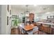 Open-concept dining area with modern light fixture, hardwood floors, and views to the exterior at 139 W Granada Rd, Phoenix, AZ 85003