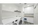 Well-organized laundry room with front load washer/dryer, cabinetry, and stylish tile flooring at 139 W Granada Rd, Phoenix, AZ 85003