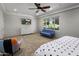 Bedroom with sitting area, carpet, TV, and a large window with views of greenery and lots of natural light at 14749 E Pecos Rd, Gilbert, AZ 85295