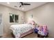 Bright bedroom is playfully decorated with a comfortable bed, ceiling fan, and sunny window at 14749 E Pecos Rd, Gilbert, AZ 85295