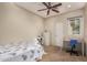 Bedroom features a ceiling fan, carpet, and an adjacent desk space at 14749 E Pecos Rd, Gilbert, AZ 85295