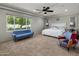 Bedroom with sitting area, carpet, and a large window with views of greenery and lots of natural light at 14749 E Pecos Rd, Gilbert, AZ 85295