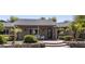 Inviting home entrance featuring a decorative glass door and manicured front yard with palm trees at 14749 E Pecos Rd, Gilbert, AZ 85295