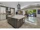 Spacious kitchen with a large island, stainless steel appliances, and access to the outdoor area at 14749 E Pecos Rd, Gilbert, AZ 85295