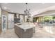 Gourmet kitchen with a large island, modern appliances, and stylish pendant lighting at 14749 E Pecos Rd, Gilbert, AZ 85295