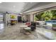 Open living space features tile floors and large glass doors to outdoor entertaining space with pool at 14749 E Pecos Rd, Gilbert, AZ 85295