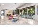 Open living space features a pink sofa, tile floors, and large glass doors to outdoor patio and entertaining space at 14749 E Pecos Rd, Gilbert, AZ 85295