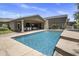 A backyard featuring a large in-ground pool, patio, and well-kept landscaping at 14749 E Pecos Rd, Gilbert, AZ 85295