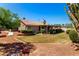 View of the home's exterior from the backyard featuring a manicured lawn and patio at 1538 W Wagner Dr, Gilbert, AZ 85233