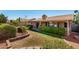 Manicured lawn in the backyard with desert landscaping and covered patio area at 1538 W Wagner Dr, Gilbert, AZ 85233