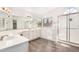 Bright bathroom featuring a walk-in tub, a walk-in shower and dual sink at 1538 W Wagner Dr, Gilbert, AZ 85233
