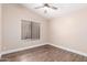 Empty bedroom with ceiling fan, window with blinds, and wood-look flooring at 1538 W Wagner Dr, Gilbert, AZ 85233