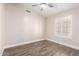 Empty bedroom with wood-look flooring, ceiling fan and window with shutters at 1538 W Wagner Dr, Gilbert, AZ 85233