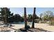 Community pool surrounded by palm trees and plenty of lounge chairs at 1538 W Wagner Dr, Gilbert, AZ 85233