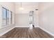 Dining room features wood-look floors, shuttered window, and a modern chandelier, creating an elegant and inviting space at 1538 W Wagner Dr, Gilbert, AZ 85233