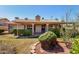 The home's exterior shows the patio area, manicured landscaping and Spanish tile roof at 1538 W Wagner Dr, Gilbert, AZ 85233