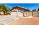 Two-car garage of a charming single-story home with tile roof and low-maintenance desert landscape at 1538 W Wagner Dr, Gilbert, AZ 85233