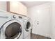 Laundry room with washer, dryer, cabinets, and utility sink at 1538 W Wagner Dr, Gilbert, AZ 85233