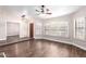 Bright living room with wood-look floors, a ceiling fan, and large windows, providing a comfortable and airy ambiance at 1538 W Wagner Dr, Gilbert, AZ 85233