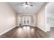 Open living room with hardwood floors and backyard access through French doors at 1538 W Wagner Dr, Gilbert, AZ 85233