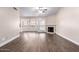 Bright living room showcasing wood-look floors, a cozy fireplace, and large windows providing ample natural light at 1538 W Wagner Dr, Gilbert, AZ 85233