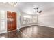Inviting living room boasts abundant natural light, wood-look floors, modern fixtures, and a lovely entry door at 1538 W Wagner Dr, Gilbert, AZ 85233