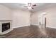Open living room with hardwood floors featuring an archway and fireplace at 1538 W Wagner Dr, Gilbert, AZ 85233