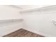 Empty walk-in closet with multiple shelves and wood-look flooring at 1538 W Wagner Dr, Gilbert, AZ 85233