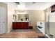 Bathroom with double sinks, spacious mirror, private toilet, and walk-in shower and bathtub at 18484 W Westfall Way, Surprise, AZ 85374