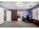 Large bedroom featuring sliding barn door to bathroom, ample closet space, and lots of natural light at 18484 W Westfall Way, Surprise, AZ 85374