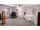 A cozy bedroom featuring a lilac wall, plush carpet, and ceiling fan at 18484 W Westfall Way, Surprise, AZ 85374