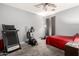 Functional bedroom featuring a ceiling fan, plush carpet, and a home workout center at 18484 W Westfall Way, Surprise, AZ 85374