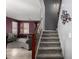 View of the home's entryway with staircase, modern light fixtures, and a peek at the living room at 18484 W Westfall Way, Surprise, AZ 85374