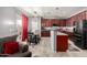 Modern kitchen with dark wood cabinets, stainless steel appliances, and an adjacent dining area at 18484 W Westfall Way, Surprise, AZ 85374