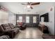Inviting living room featuring sleek floors, fan, and Ohio State Buckeyes themed decorations at 18484 W Westfall Way, Surprise, AZ 85374